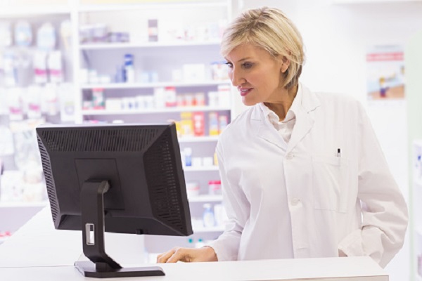 Pharmacist using the computer at pharmacy